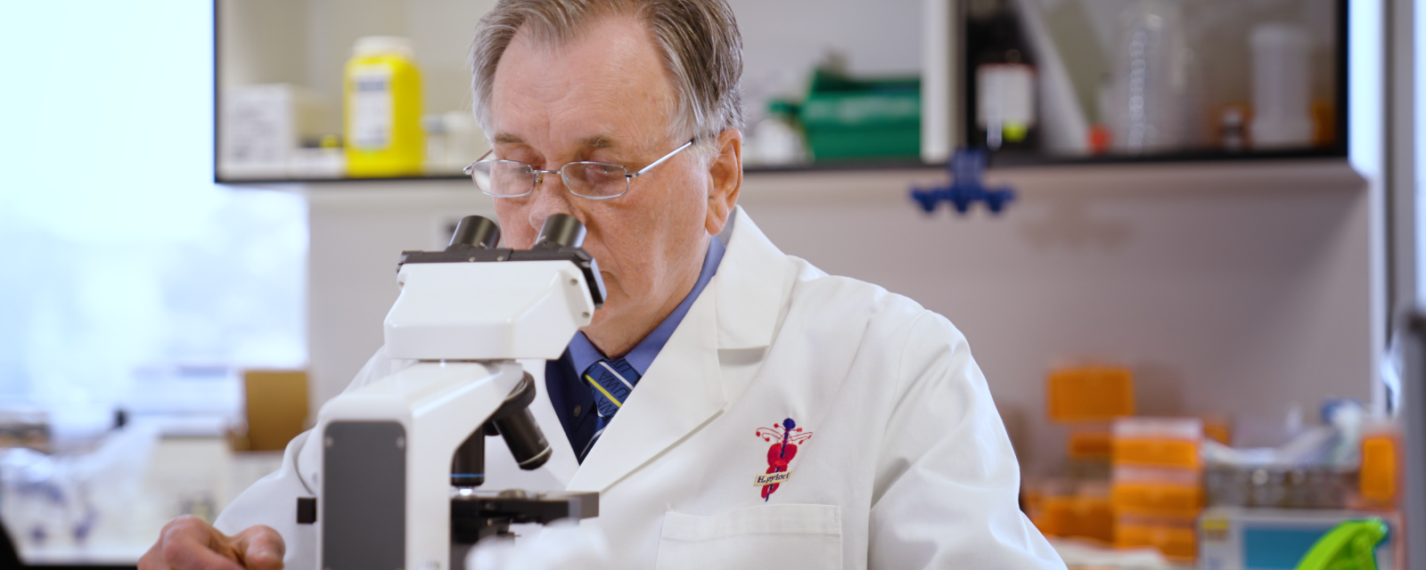 Barry Marshall looking through microscope. 